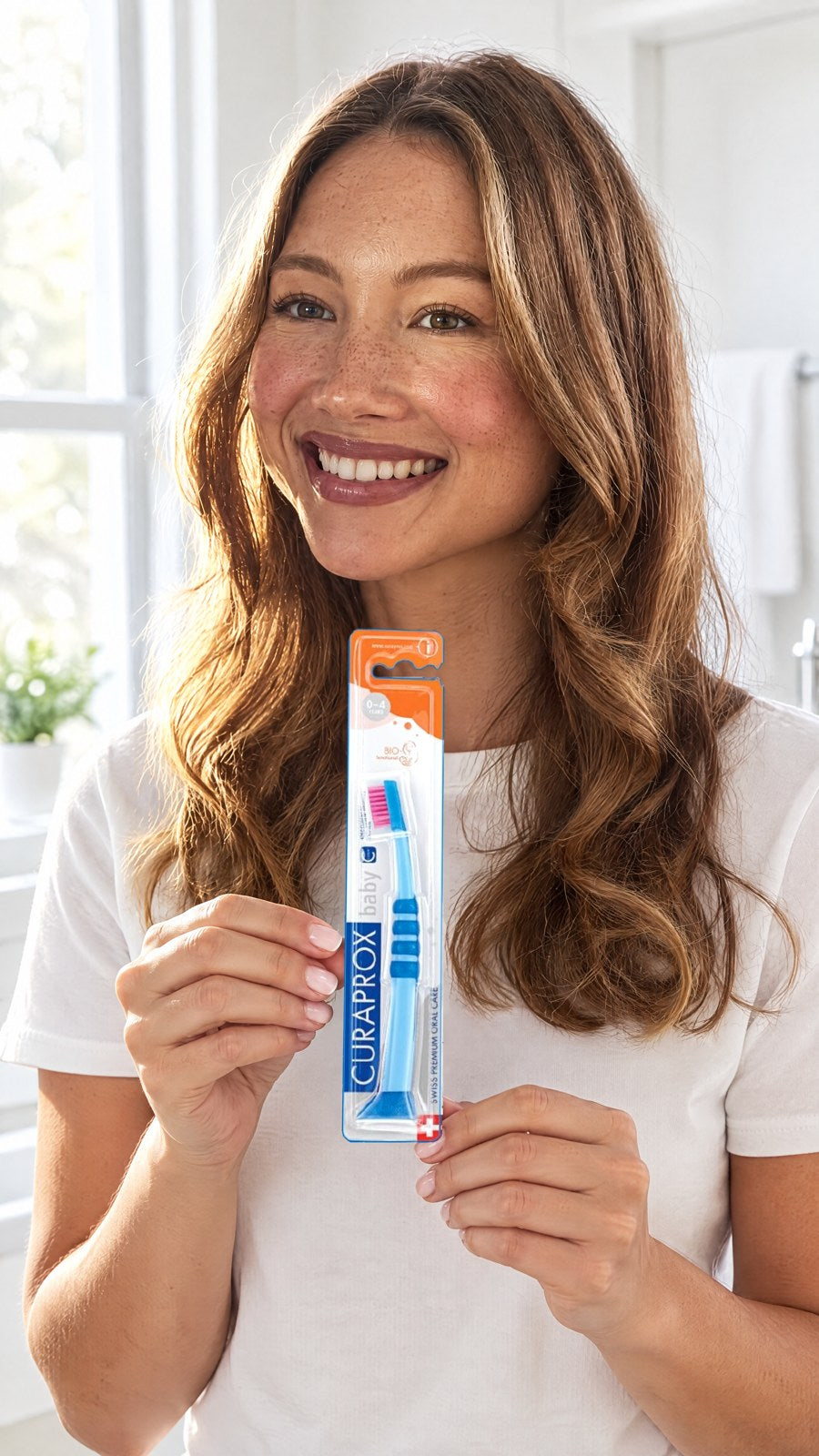CURAPROX - Curaprox Baby Blue Ultra Soft Toothbrush (Age: 0-4 years) — held by model