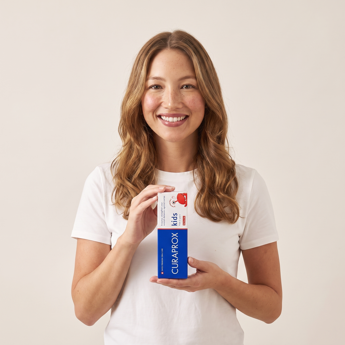 Curaprox Kids toothpaste box in hand